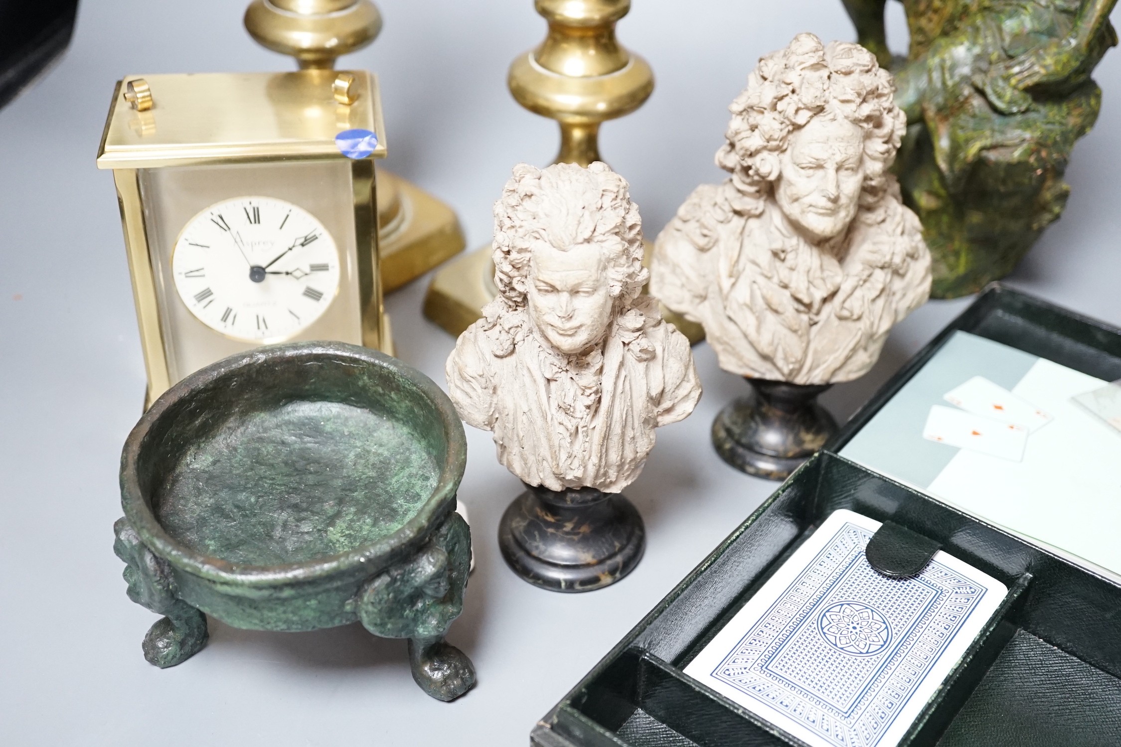 A pair of small terracotta busts after Chinard, a glazed pottery figure, a pair of Victorian brass candlesticks, Asprey retailed timepiece etc. tallest 25cm
